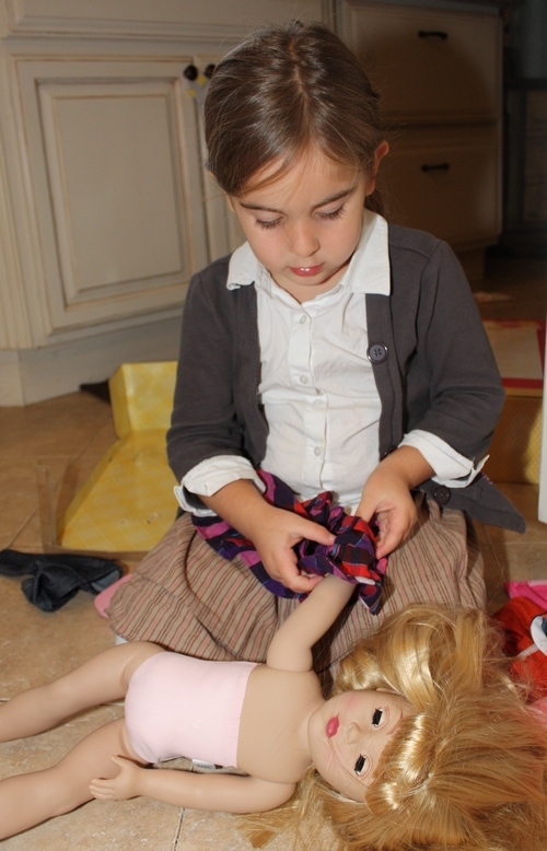 Child playing with Dollie and Me doll