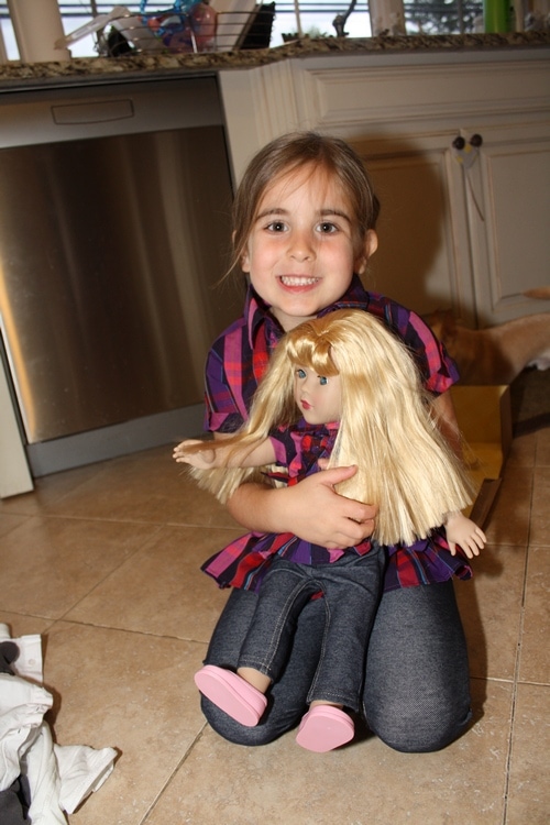 Child playing with Dollie and Me doll