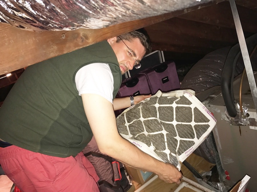 husband changing HVAC filter