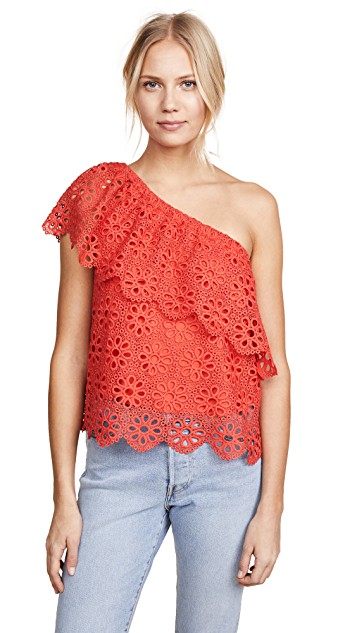 woman in red lace one shoulder shirt and jeans
