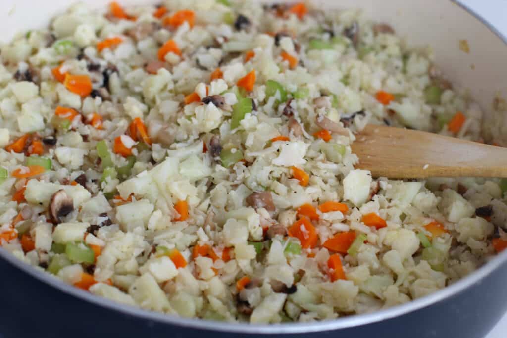Keto Cauliflower carrots, celery, onions sautéing in pan