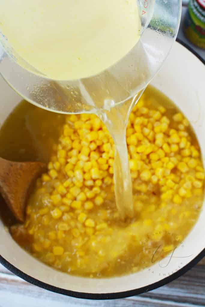 Large pot with corn soup ingredients