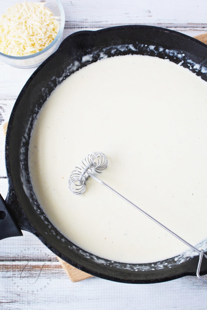 Add your heavy whipping cream and cream cheese and then season with salt and pepper. Heat over medium heat, whisking frequently until smooth and hot. 